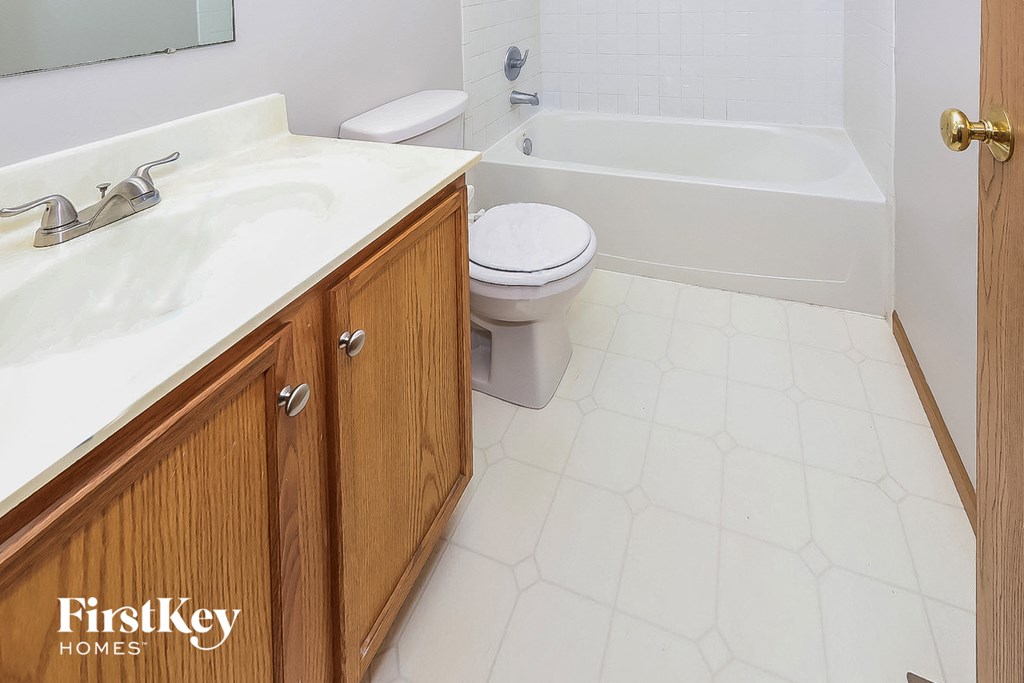 a bathroom with a sink toilet and a bath tub