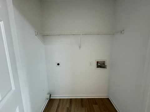 a room with white walls and a white ceiling and a picture on the wall