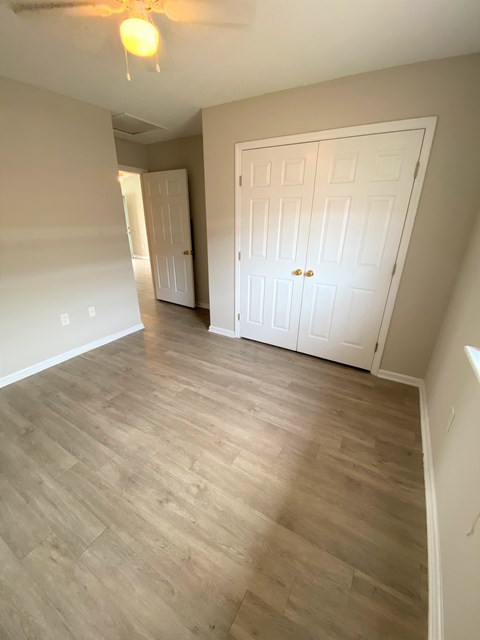 a living room with wood flooring and a white door
