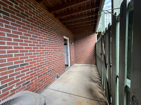 a brick hallway with a door to a brick building