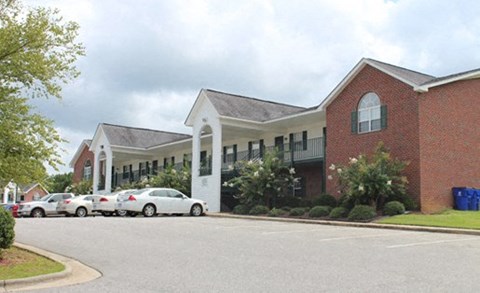 A red brick building with a white trim and a black roof.