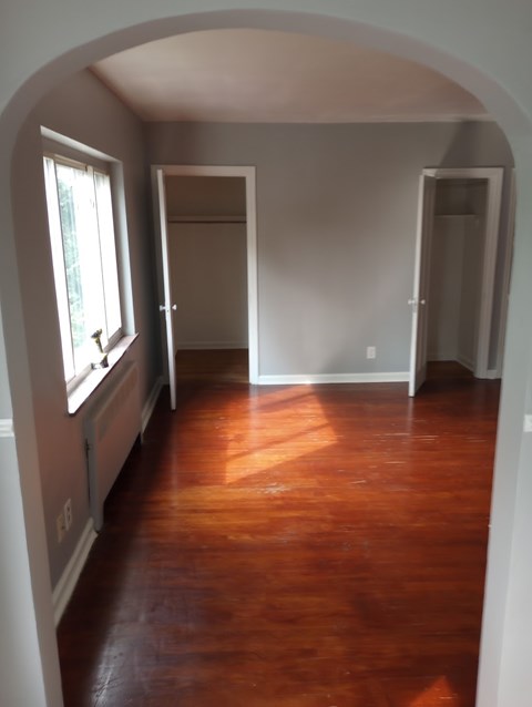 A room with wooden floors and white walls.
