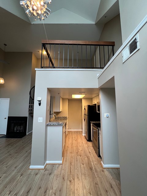 A large open living space with a staircase leading to the upper floor.