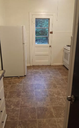 a kitchen with a refrigerator and a stove in it