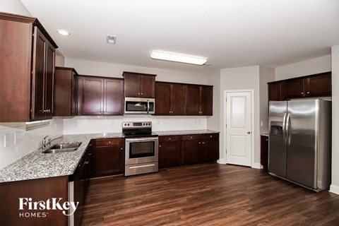 A kitchen with wooden cabinets and stainless steel appliances.