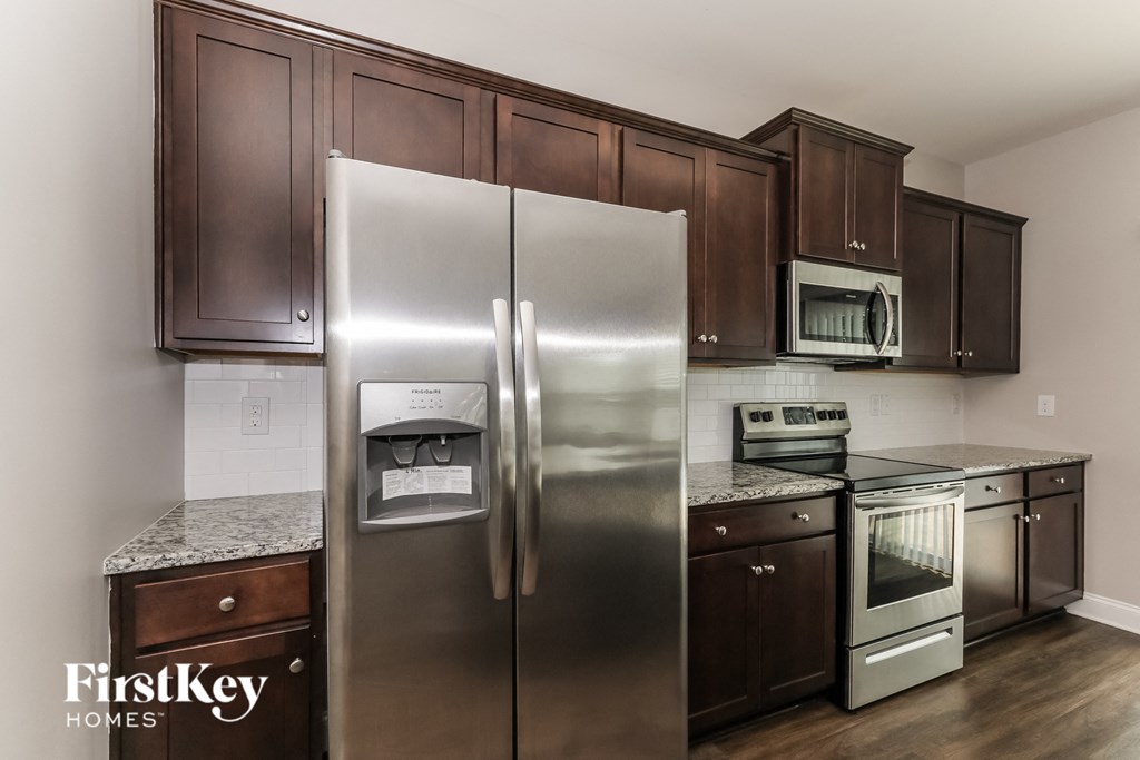 a kitchen with stainless steel appliances and wooden cabinets
