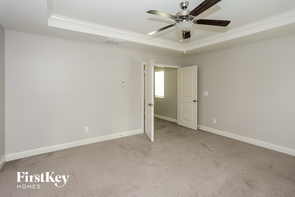 a empty living room with a ceiling fan