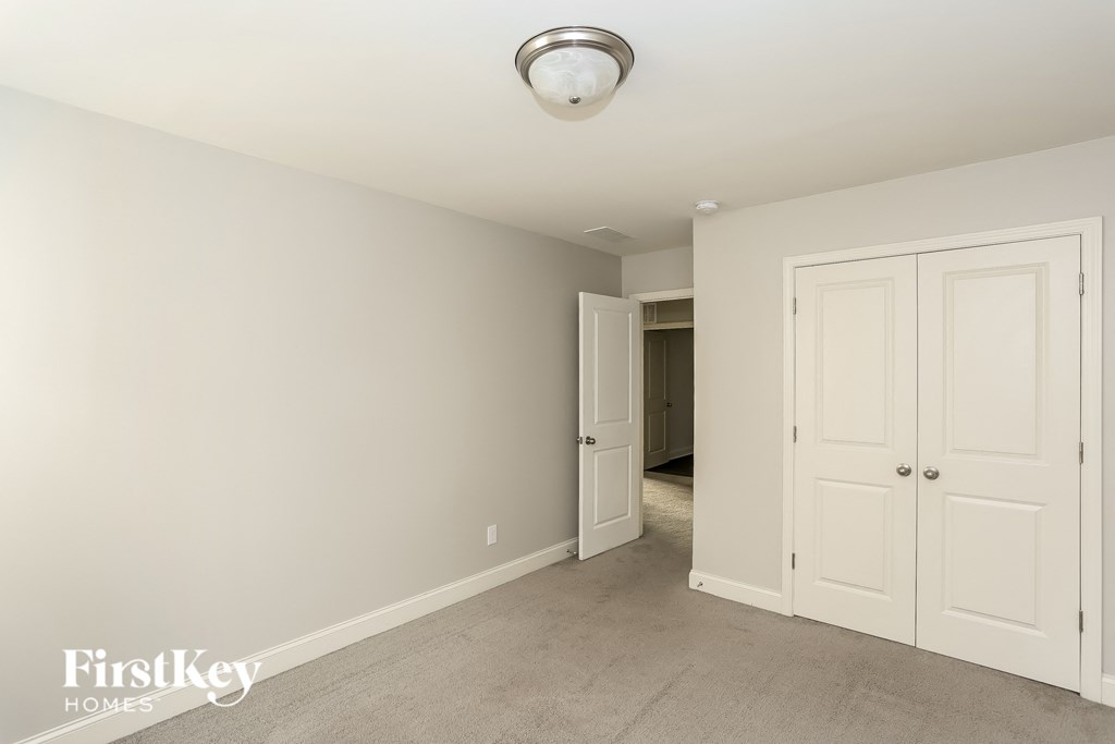 a bedroom with two closets and a door to a hallway