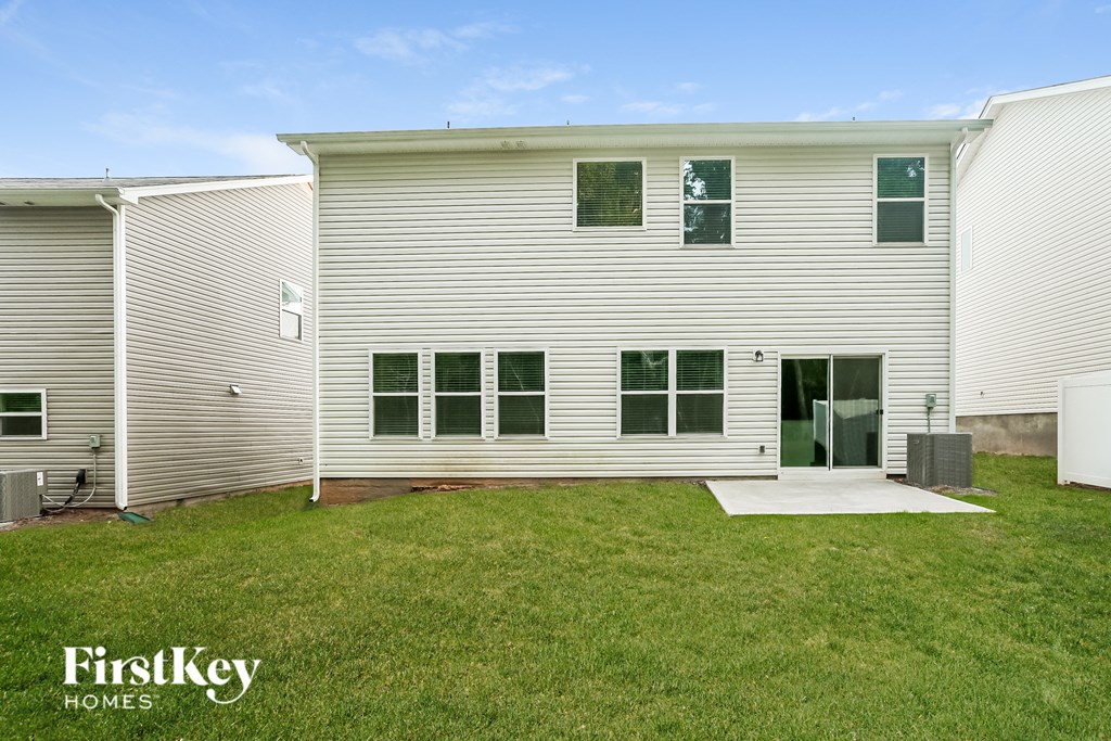 a white house with a yard in front of it