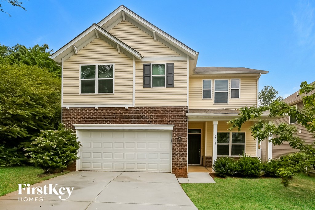 a tan house with a white garage door