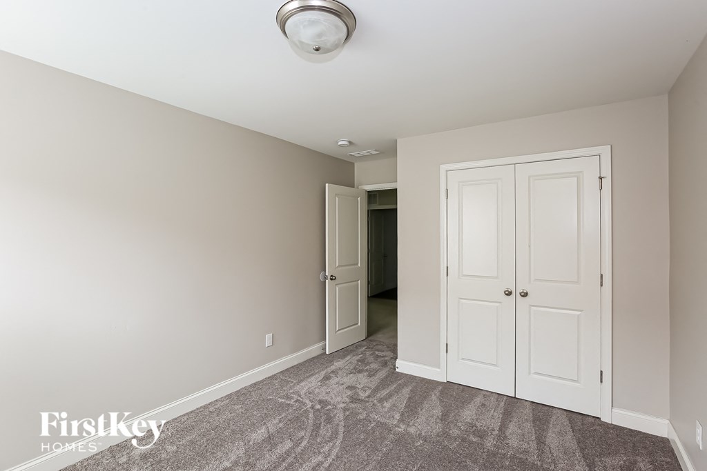 a bedroom with two closets and a door to a hallway