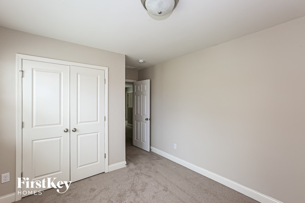 a bedroom with two closets and a door to a hallway