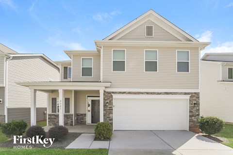 a beige house with a white garage door