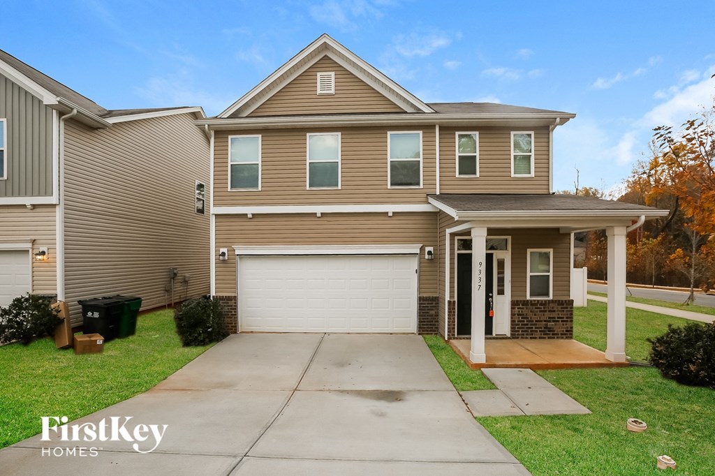 A two-story house with a garage is for sale by FirstKey Homes.