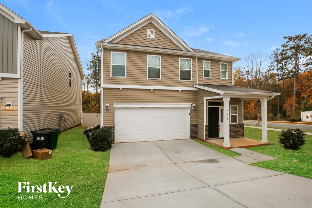 A two-story house with a garage is for sale by FirstKey Homes.