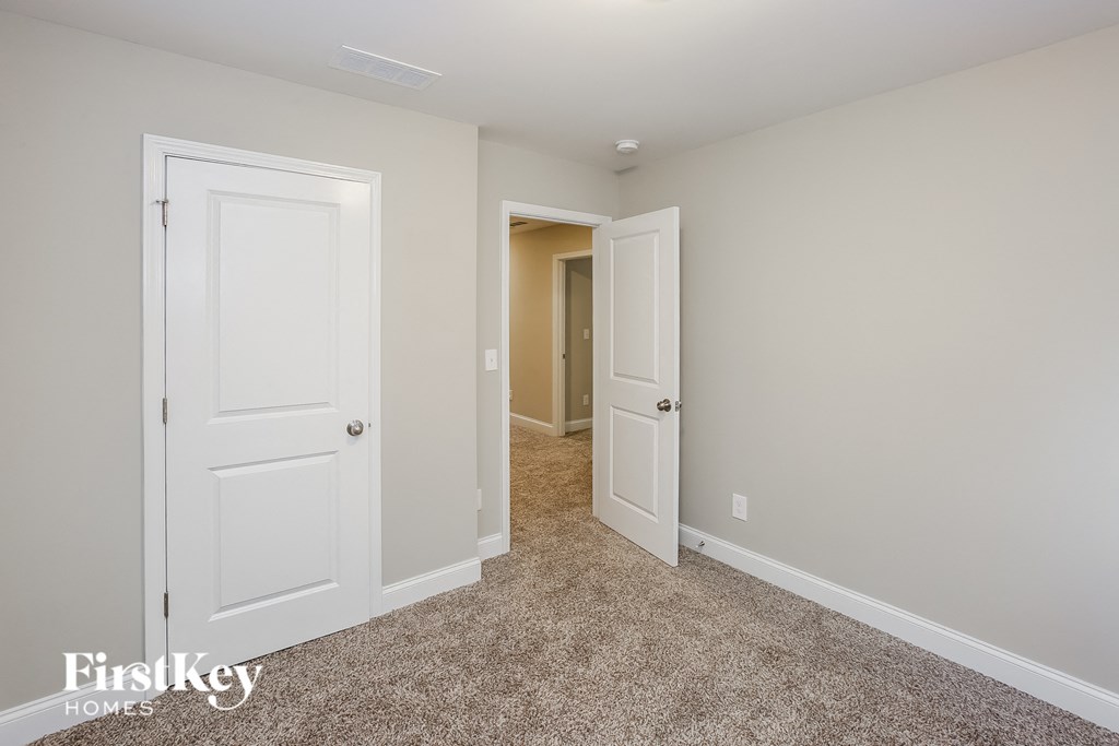 A room with two doors, one of which is open.