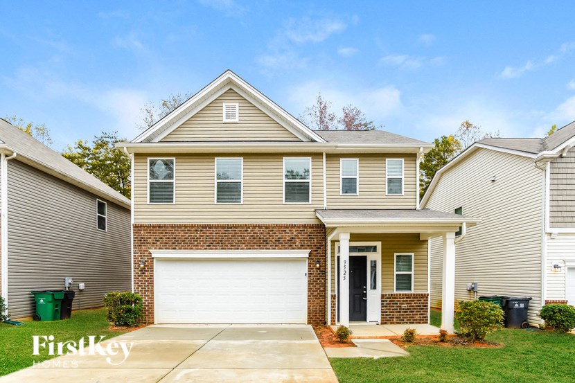 A two-story house with a garage is for sale.