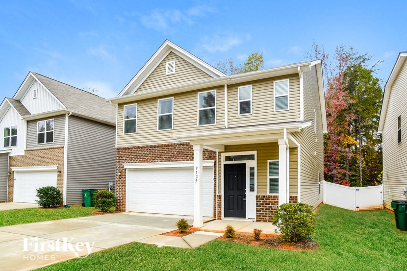 A two-story house with a garage is for sale.
