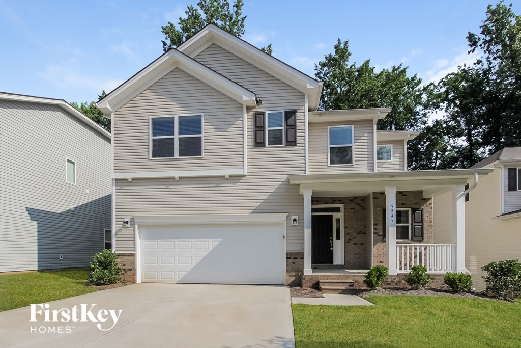 a beige house with a white garage door