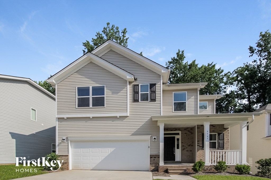 a beige house with a white garage door