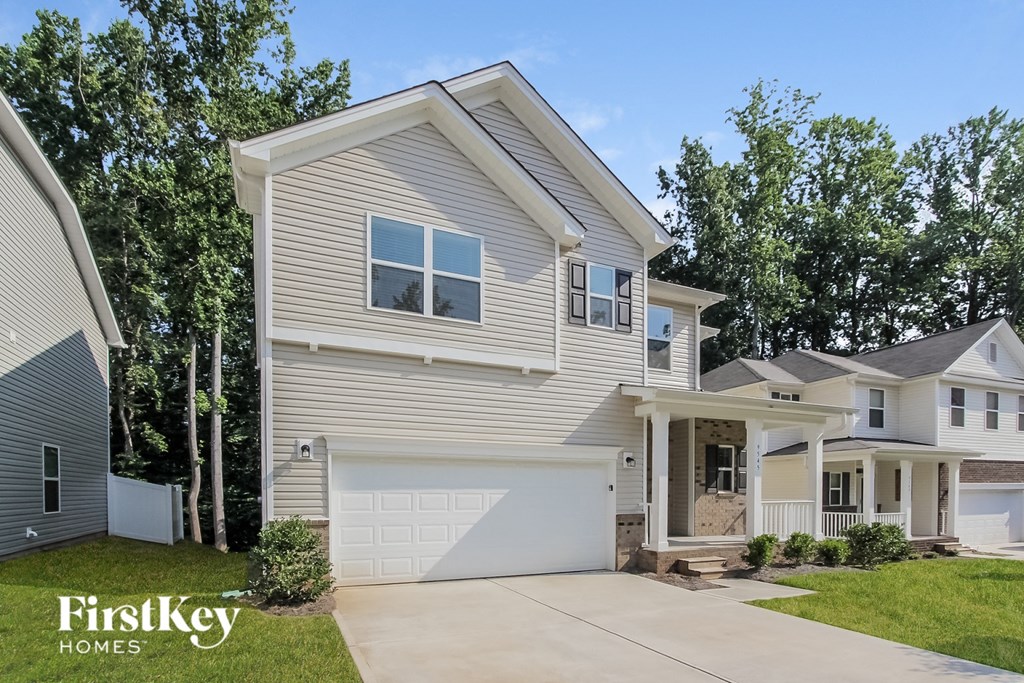a beige house with a white garage door