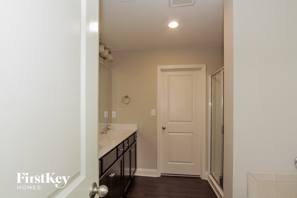 a bathroom with a sink and a mirror and a shower