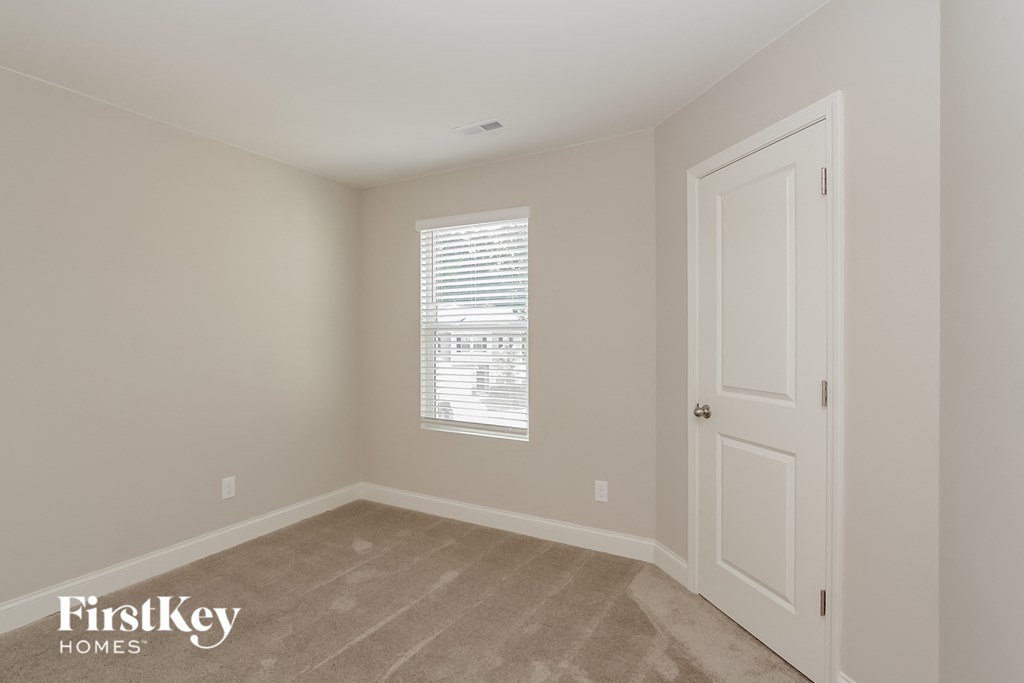 a bedroom with a white door and a window