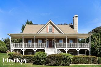 a large white house with a wrap around porch