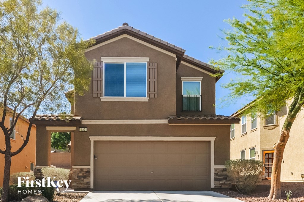 A house with a brown roof and a garage door.