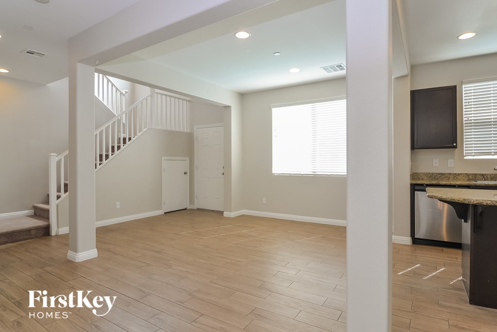 A spacious living room with a staircase and a television.