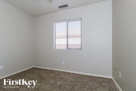 the living room of a home with a window and carpet