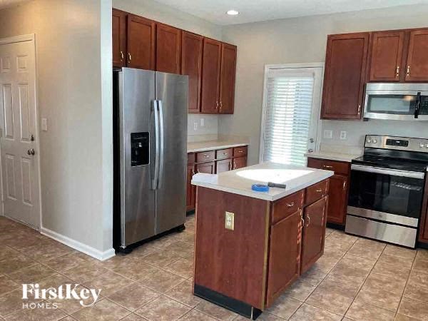 a kitchen with a stainless steel refrigerator