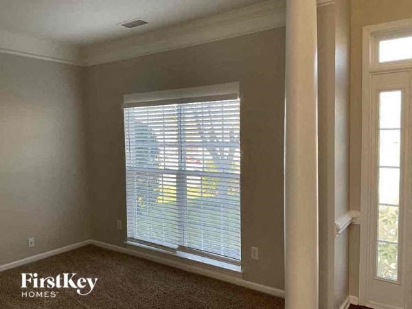 a living room with a large window and a door