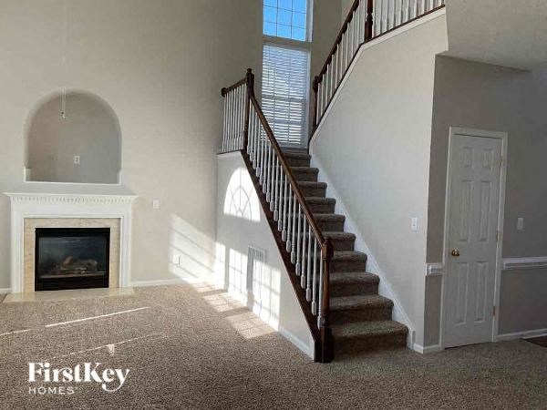 a stairway in a house with a fireplace