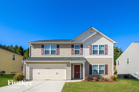 a beige house with a white garage door