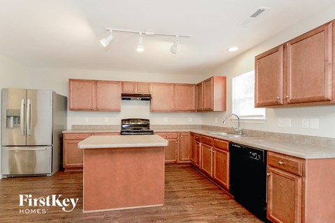 a kitchen with wooden cabinets and stainless steel appliances and a counter top