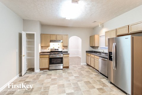 a kitchen with stainless steel appliances and wooden cabinets
