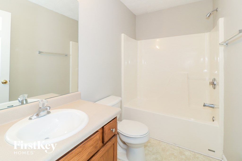 a bathroom with a sink toilet and a shower
