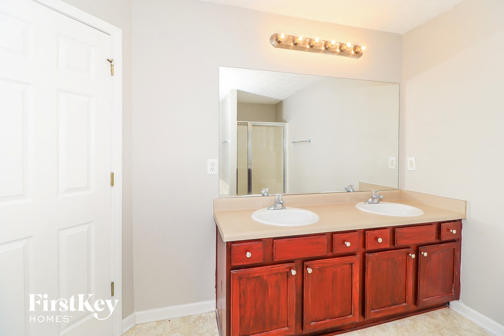 a bathroom with two sinks and a large mirror