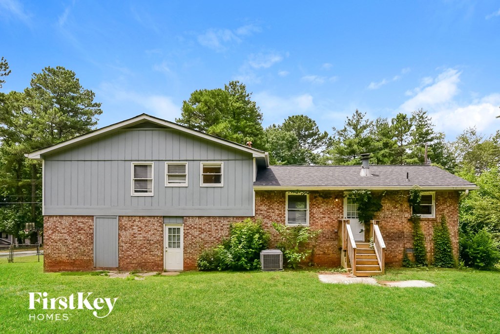 a brick house with a gray roof and a gray garage