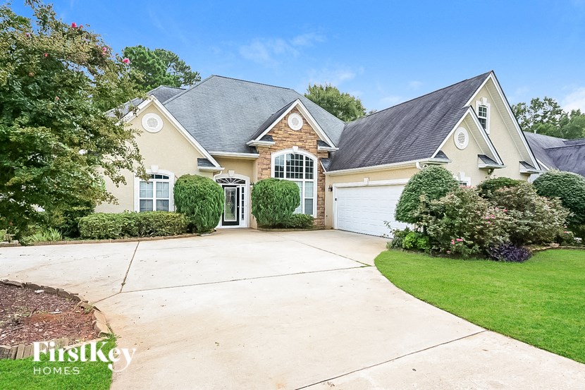 a large house with a driveway and a garage door