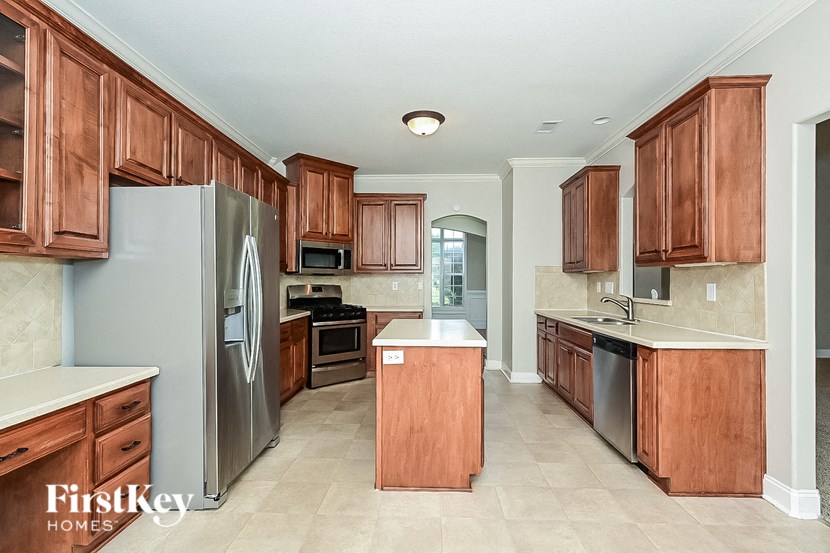 a kitchen with wooden cabinets and stainless steel appliances