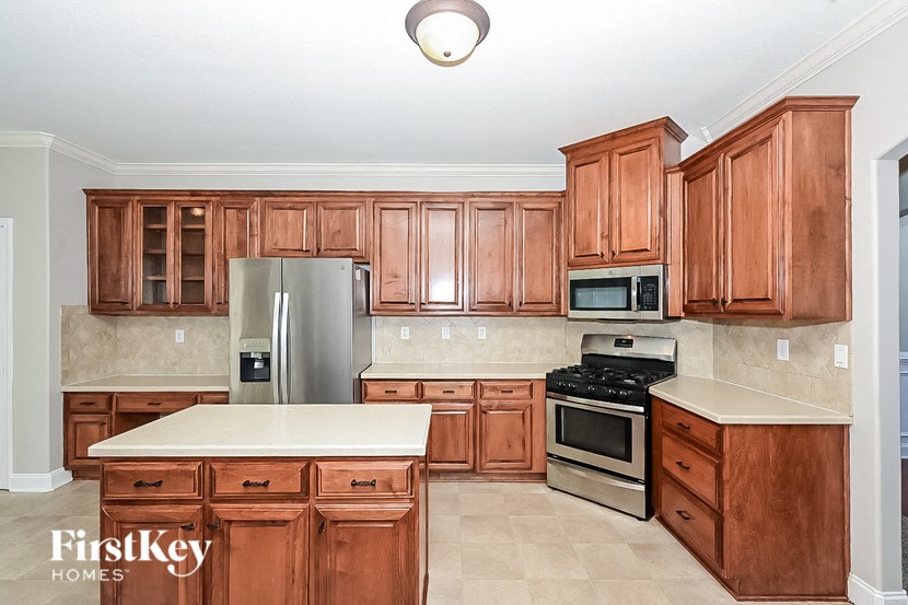 a kitchen with wooden cabinets and stainless steel appliances