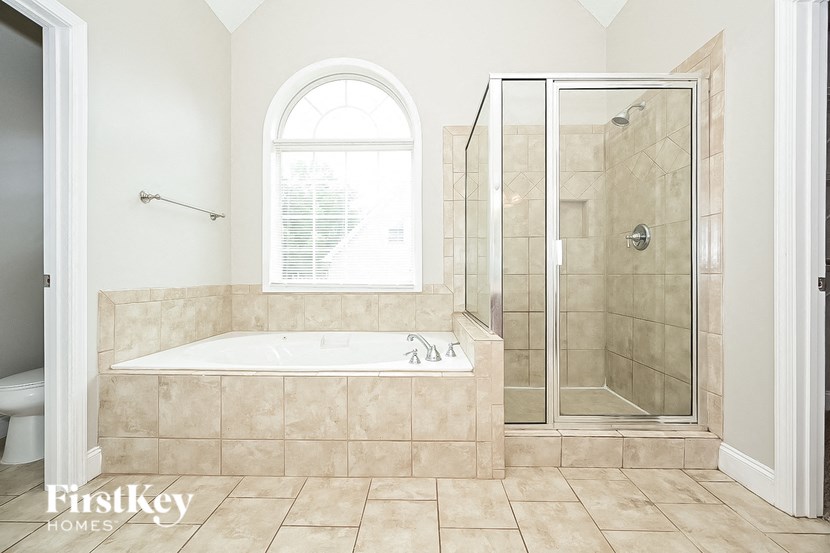 a small bathroom with a tub and a shower