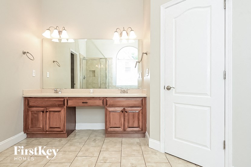 a bathroom with a vanity and a large mirror