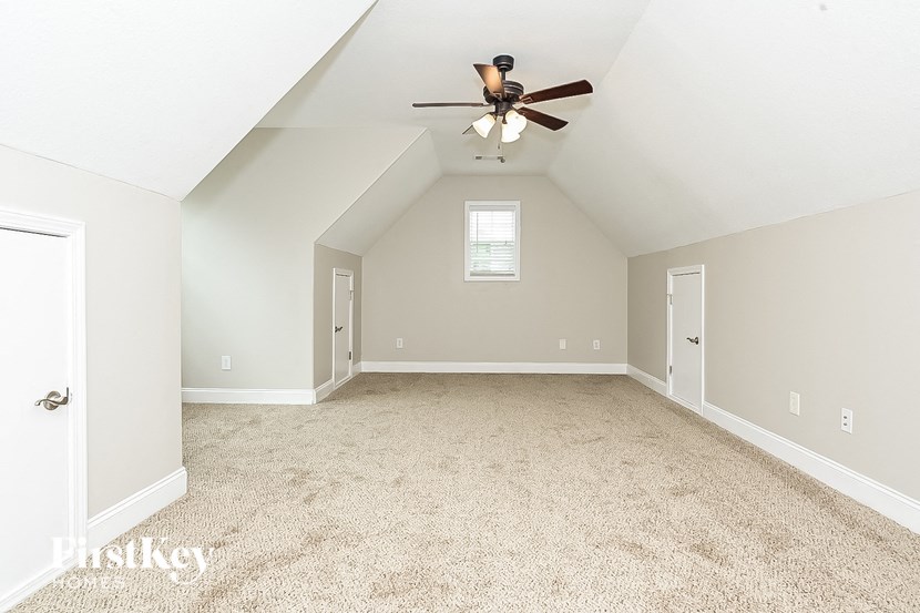 the master bedroom is spacious and has a ceiling fan