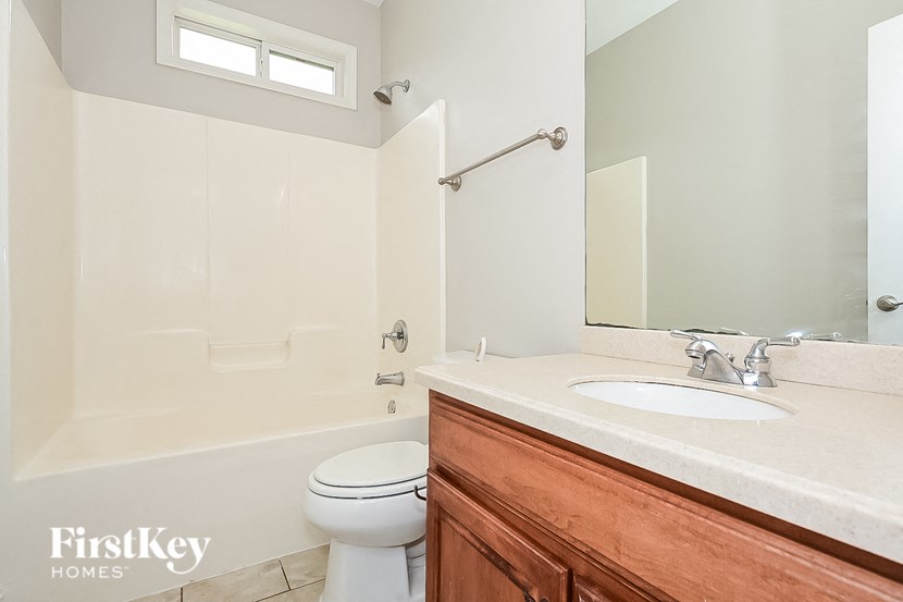 a bathroom with a sink toilet and a mirror