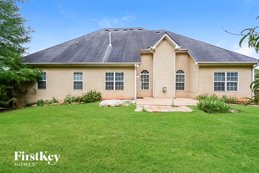 a home with a green lawn and a roof