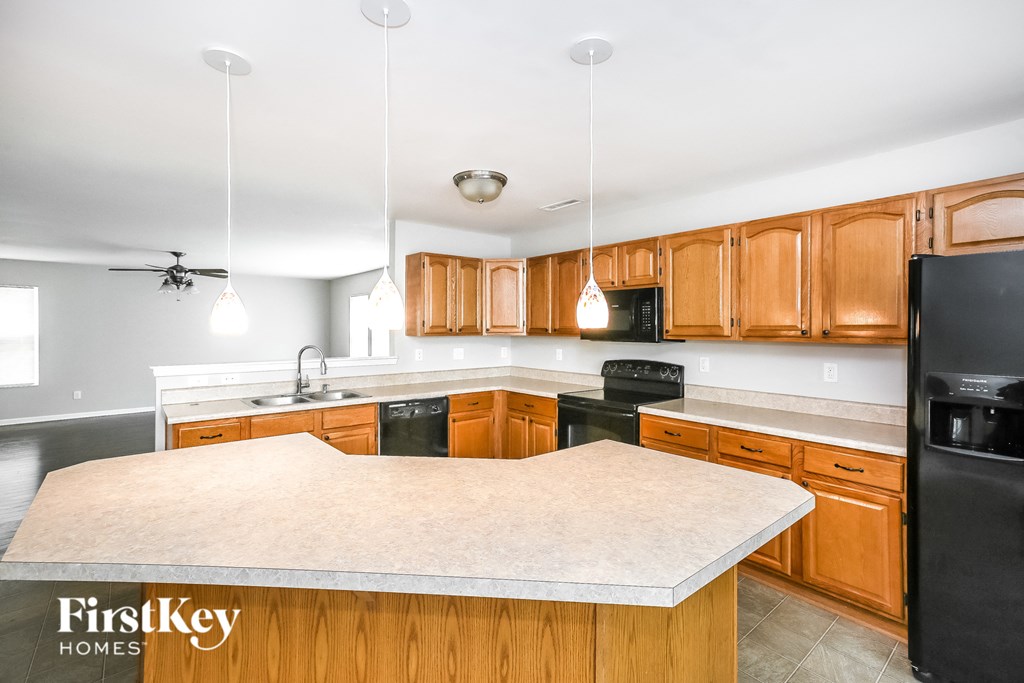 a kitchen with wooden cabinets and a white counter top