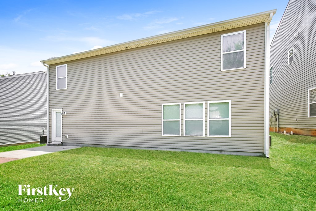 a side view of a house with a yard and grass